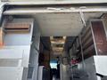 A 2011 Workhorse W62 interior showcasing shelves cabinets and storage compartments along the sides