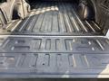 The image shows the bed of a 2021 Ford F-150 with a textured surface and metallic finish designed for cargo storage and hauling