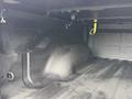 The image shows the interior of a 2018 RAM 1500 truck bed with a textured, black liner and a prominent molded section for added cargo space