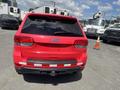 Rear view of a red 2015 Jeep Grand Cherokee showcasing its distinctive taillights and Jeep logo
