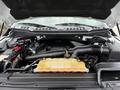 The engine compartment of a 2018 Ford F-150 showing the view of the engine with visible components like the air intake and coolant reservoir