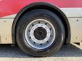 Close-up of a 2016 Grande West Vicinity bus wheel showcasing a silver rim with multiple bolt holes and a black tire labeled with the word Winter
