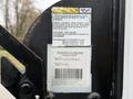 2008 Chevrolet Express with visible lifting mechanism and warning label on a lift gate providing maintenance instructions and specifications