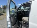 A 2017 Chevrolet Express with the driver's side door open showing the interior, including the steering wheel and seating area