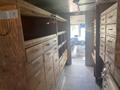 Interior of a 2007 Morgan Olson Workhorse W42 with wooden shelving and storage drawers along the sides