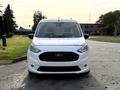 A white 2019 Ford Transit Connect with a black grille and headlights facing directly forward