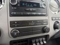 Dashboard controls of a 2011 Ford F-650 featuring audio system climate controls and multiple knobs for fan and air conditioning регулировка