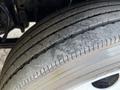 Close-up of a worn tire on a 2016 Isuzu NRR showing tread wear and dirt on the rubber surface