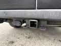 A close-up of the hitch receiver on a 2020 RAM Promaster showing the square opening and electrical connector mounted underneath