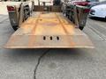 A 2013 JLG Industries 1014 trailer with a weathered metal surface and ramp extending from the back showing signs of rust and wear