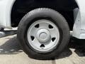 A close-up of a white wheel and tire of a 2008 Ford F-250 SD showing the five-spoke wheel design and black tire tread