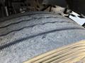 Close-up of a worn tire with visible tread patterns and signs of wear on a 2017 Ford F-650 Super Duty
