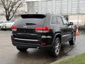 A black 2019 Jeep Grand Cherokee limited model is shown from the rear with a visible brand logo and alloy wheels