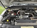 Engine compartment of a 2015 Ford F-450 showing various components including the air intake system battery and hoses