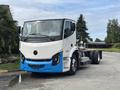 A 2020 Lion Lion6 electric truck featuring a white and blue design with a cabin, large windshield, and missing cargo area showing the chassis and wheels
