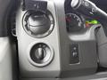 Dashboard controls of a 2017 Ford E450 including knobs for headlights and dashboard settings