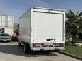 A white 2023 Ford E-450 box truck with a smooth rear panel and a loading lift gate attached