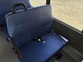 A blue upholstered seat with a safety belt designed for installation in a 2020 Chevrolet Express
