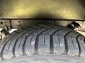 Close-up of a tire tread on a 2017 Ford Transit-350 showcasing its deep grooves and textured surface designed for traction and stability