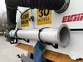 A metal pipe attached to a truck with hoses and a warning sign indicating 30 metres keep back