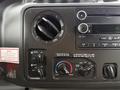 Dashboard controls of a 2017 Ford E450 including climate controls and audio system buttons