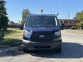 A blue 2016 Ford Transit 150 van is shown from the front with a roof light and a black grille