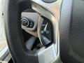 Close-up of the steering wheel controls on a 2021 Ford Transit Connect showing buttons for setting cruise control