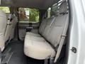 The interior of a 2019 Ford F-350 SD showing a spacious rear bench seat with light gray upholstery and seat belts