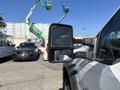 A 2011 Ford F-550 with a side mirror visible in the foreground