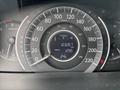A close-up view of the dashboard of a 2014 Honda CR-V showing the speedometer, odometer reading 103267 km, trip meter at 129.5 km, and temperature gauge displaying 24 degrees Celsius
