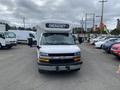 A 2020 Chevrolet Express van with a white exterior and "EMERGENCY" sign on the front grille
