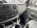 Interior view of a 2009 Ford Econoline showing the dashboard with radio controls and storage compartments