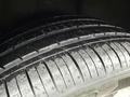 Close-up of a tire from a 2016 Mercedes-Benz GLA-250 featuring a tread pattern with some water droplets on the surface