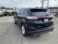 A 2017 Ford Edge SUV in black with a rear view showcasing its design and taillights