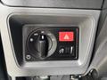 Control panel with various switches including a knob for auto lighting and a hazard light button