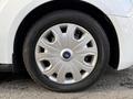 A close-up view of a silver wheel hubcap on a 2019 Ford Transit Connect with a black tire