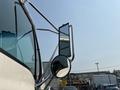 A close-up view of the side mirror of a 2006 Sterling Acterra truck with a curved metal frame and a rectangular side mirror
