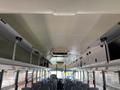 Interior view of a 2009 International 3000 CE school bus featuring overhead storage compartments and rows of gray seats