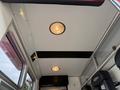 Interior view of a 2007 Ford F-550 ambulance featuring ceiling lights and interior paneling with an empty seating area visible