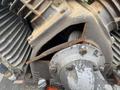 Close-up of a Baldor Air compressor showing the motor and internal components with rusted metal parts and exposed areas