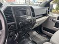 The interior of a 2017 Ford F-150 showing the dashboard with controls and display screen in focus
