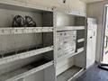 Interior of a 2007 GMC C4500 TopKick displaying metal shelving units with organized drawers and compartments for storage
