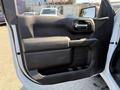 A white 2022 GMC Sierra 1500 with a sleek door panel design featuring a handle and a smooth armrest area