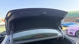 The trunk of a 2018 Hyundai Sonata is open showcasing the interior space and trunk lining
