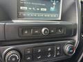 Dashboard controls of a 2016 Chevrolet Silverado 2500HD featuring audio system display buttons for tuning and climate settings