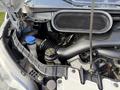 Close-up view of the engine compartment of a 2016 Ford Transit showing various components like hoses and fluid reservoirs