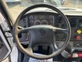Steering wheel of a 2016 Freightliner M2 106 with dashboard gauges and controls visible