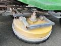 A yellow and gray rotary broom attachment mounted on a vehicle with a green body showcasing bristles along the edge for sweeping surfaces