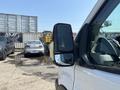 A 2019 Ford Transit 350 with a focus on the side mirror showing a reflective surface and the vehicle's profile