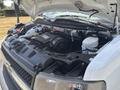 A 2020 Chevrolet Express engine with exposed components including the air intake fuel system and battery